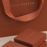 Brown packaging with 'Sarah Foster' branding on a light background