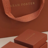 Brown packaging with 'Sarah Foster' branding on a light background